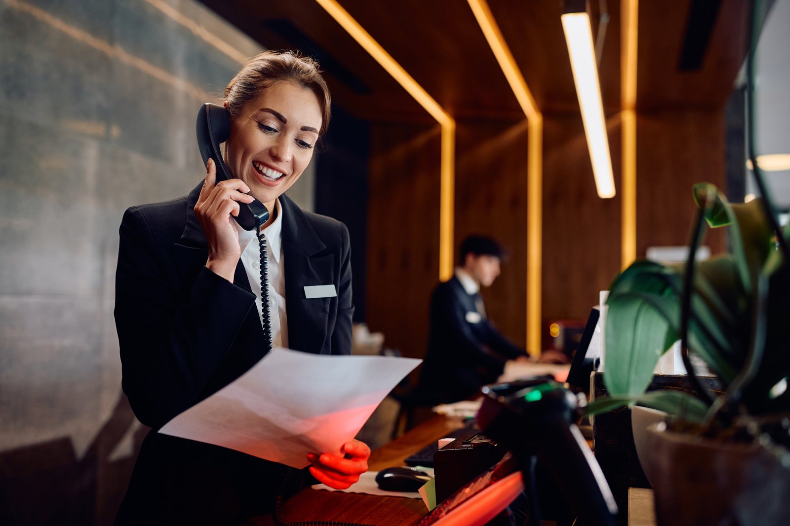 Hotel receptionist managing guest communications